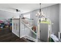 Welcoming entryway showcases the staircase with white railing, chandelier, and arched window creating a bright and airy ambiance at 680 Harbor Point Ct, Lawrenceville, GA 30044