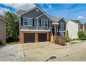 Two story home with gray siding, a brick facade, and black garage doors, offering a classic and appealing curb appeal at 680 Harbor Point Ct, Lawrenceville, GA 30044
