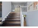 A view of the staircase leading to an upper level, featuring wooden steps and a white banister at 680 Harbor Point Ct, Lawrenceville, GA 30044