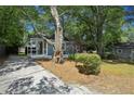 Inviting exterior view of home with a covered porch, driveway, and mature trees at 2130 Main Nw St, Atlanta, GA 30318