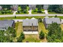 Aerial view of home's backyard with patio, surrounded by lush greenery, in a serene, suburban neighborhood at 2445 Whitehead Place Dr, Suwanee, GA 30024