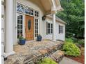 Inviting front porch features stone steps, classic columns, and a wooden front door at 434 Westlake Nw Dr, Marietta, GA 30064