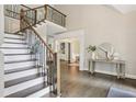 Elegant staircase featuring hardwood steps, iron railings, and a view of the open foyer at 434 Westlake Nw Dr, Marietta, GA 30064