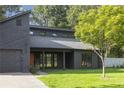 Modern dark wood home with attached garage, lush green lawn, and stylish front windows at 600 Applewood Nw Ln, Marietta, GA 30064