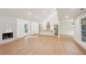 Bright and modern living space featuring wood floors, a fireplace, and an open floor plan connected to the kitchen at 600 Applewood Nw Ln, Marietta, GA 30064