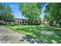 View of the complex showing the manicured lawn and mature trees. An inviting place to call home at 50 Le Parc Fontaine, Lithonia, GA 30038