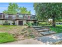 Condo with mature landscaping and stairs leading up to the front entrance for a pleasant curb appeal at 50 Le Parc Fontaine, Lithonia, GA 30038