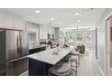 Bright, updated kitchen boasts an island with marble countertops and modern stainless steel appliances at 524 Paines Nw Ave, Atlanta, GA 30318