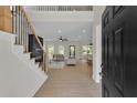 Bright entryway with hardwood floors, a staircase with wrought iron railing, and a view into the open living area at 1128 E Shoreview Rd, Mcdonough, GA 30253