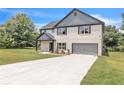 Beautiful painted-brick two-story home with well-maintained lawn, two-car garage, and classic black shutter accents at 1128 E Shoreview Rd, Mcdonough, GA 30253