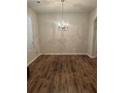 Dining room featuring gleaming hardwood floors and a elegant chandelier at 5752 Little River Rd, Atlanta, GA 30349