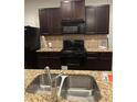 Updated kitchen with granite countertops, stainless steel sink, and modern appliances at 5752 Little River Rd, Atlanta, GA 30349