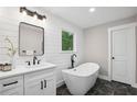 Stylish bathroom featuring a modern soaking tub, sleek vanity, and elegant fixtures at 942 Mclinden Se Ave, Smyrna, GA 30080