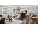 Open-concept living space with hardwood floors, kitchen with island, and dining area at 942 Mclinden Se Ave, Smyrna, GA 30080
