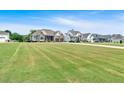 Picturesque neighborhood with well-manicured lawns and beautiful homes under a clear blue sky at 101 River Walk Pkwy, Euharlee, GA 30145