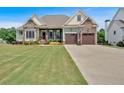 Charming home with a well-manicured lawn, stone accents, and a two-car garage with a basketball hoop at 101 River Walk Pkwy, Euharlee, GA 30145