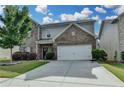 Charming two-story home with a well-manicured lawn and an attached two car garage at 1767 Weatherbrook Cir, Lawrenceville, GA 30043