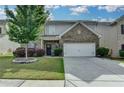 Charming two-story home with a well-manicured lawn and an attached two car garage at 1767 Weatherbrook Cir, Lawrenceville, GA 30043