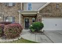 Inviting front porch with decorative bushes and a well manicured yard at 1767 Weatherbrook Cir, Lawrenceville, GA 30043