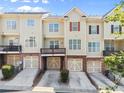 Back elevation of townhomes, each featuring an attached garage and a private balcony at 2345 Gallard St, Lawrenceville, GA 30043