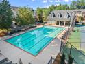 Aerial view of a community pool and tennis court surrounded by lush greenery and residential buildings at 2345 Gallard St, Lawrenceville, GA 30043