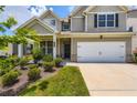 Beautiful two-story home with an attached two-car garage, tidy landscaping, and a welcoming front porch at 2486 Bear Mountain St, Lithonia, GA 30058