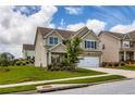 Inviting two-story home with a manicured lawn, a two-car garage, and beautiful landscaping at 2486 Bear Mountain St, Lithonia, GA 30058