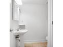 Cozy bathroom with tiled floors and a pedestal sink, perfect for guests at 149 Rondak Se Cir, Smyrna, GA 30080