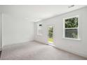 Bright bedroom with neutral carpet, three windows, and access to the backyard at 1615 Gunnin Nw Trce, Atlanta, GA 30318