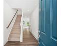 Inviting entryway with hardwood floors, a staircase with railing, and a view into other rooms at 1615 Gunnin Nw Trce, Atlanta, GA 30318