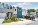 Attractive townhome featuring gray and white siding, a driveway, and manicured landscaping at 1615 Gunnin Nw Trce, Atlanta, GA 30318