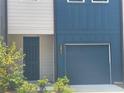 Beautiful townhome featuring an attached one-car garage and manicured landscaping at 1615 Gunnin Nw Trce, Atlanta, GA 30318