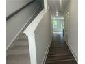 Bright hallway with wood floors, stairs, and view into living area at 1615 Gunnin Nw Trce, Atlanta, GA 30318