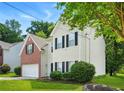 Charming two-story home with brick and siding exterior, an attached garage, and manicured landscaping at 5487 Walnut Lane Ln, Stonecrest, GA 30038