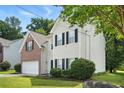 Charming two-story home with brick and siding exterior, an attached garage, and manicured landscaping at 5487 Walnut Lane Ln, Stonecrest, GA 30038