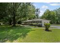 Well-maintained home featuring a spacious yard, lush trees, and a welcoming walkway at 119 Walker Nw Rd, Cartersville, GA 30121