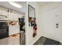 Entry to kitchen with white cabinets, black appliances, and exterior door at 4023 Stillwater Dr, Duluth, GA 30096