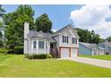 View of the home's front exterior with a well-maintained lawn and two-car garage at 1093 Athena Ct, Acworth, GA 30101