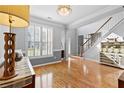 Bright dining room with hardwood floors, stylish chandelier, and ample natural light at 5054 Kingsbridge Pass, Powder Springs, GA 30127