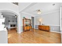 Spacious dining room with hardwood floors, elegant lighting fixture, and view of the fireplace at 5054 Kingsbridge Pass, Powder Springs, GA 30127