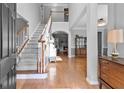 Grand foyer with hardwood floors, staircase, and views into other living spaces at 5054 Kingsbridge Pass, Powder Springs, GA 30127
