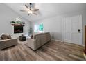 Bright living room showcases hardwood floors, a fireplace, and neutral-toned furniture, illuminated by natural light at 86 Kelly Ct, Dallas, GA 30157
