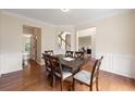 Open-concept dining area with hardwood floors, traditional wood trim, and easy access to kitchen at 1413 Eastbrooke Way, Marietta, GA 30066