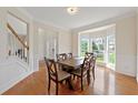 Bright dining room features hardwood floors, a large window, and decorative molding at 1413 Eastbrooke Way, Marietta, GA 30066