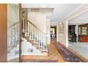 Inviting foyer with hardwood floors, staircase with white railings, and decorative rug at 4211 Schooner Ne Ct, Roswell, GA 30075
