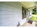 Close up of the entrance with painted siding and storm door, offering an inviting space to greet visitors at 504 Azalea Ct, Woodstock, GA 30188