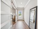 Elegant entryway featuring wood floors, modern sliding doors, and a clear view to the front door at 515 Cobblestone Ct, Canton, GA 30115