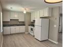 Functional kitchen featuring white appliances, ample cabinetry, and modern flooring at 7400 Little Fawn Pkwy, Palmetto, GA 30268