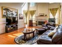 Hardwood floors and a fireplace highlight this living room with high ceilings and large windows at 2905 Olde Town Park Dr, Norcross, GA 30071