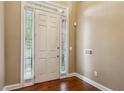 Home's foyer featuring a white front door and light hardwood floors at 2969 Rivergreen Se Ln # 23, Atlanta, GA 30339